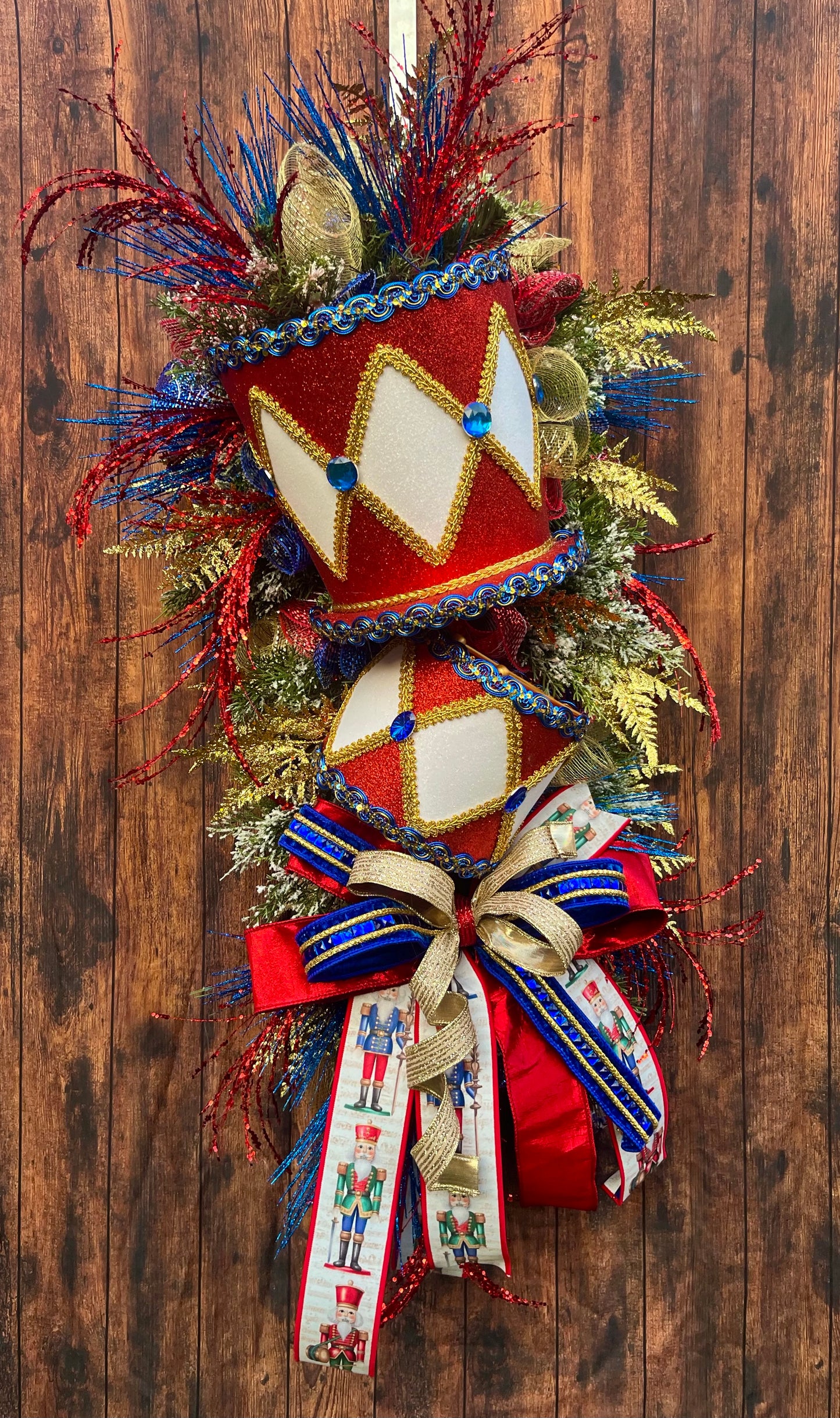 Nutcracker Drum Christmas Swag – Red, Blue & Gold Holiday Door Decor with Glitter Picks & Nutcracker Ribbon