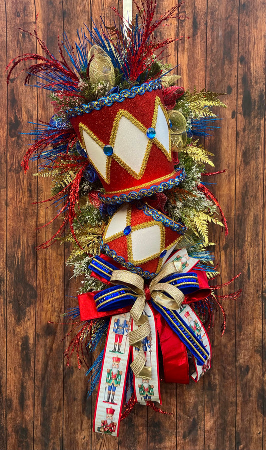 Nutcracker Drum Christmas Swag – Red, Blue & Gold Holiday Door Decor with Glitter Picks & Nutcracker Ribbon