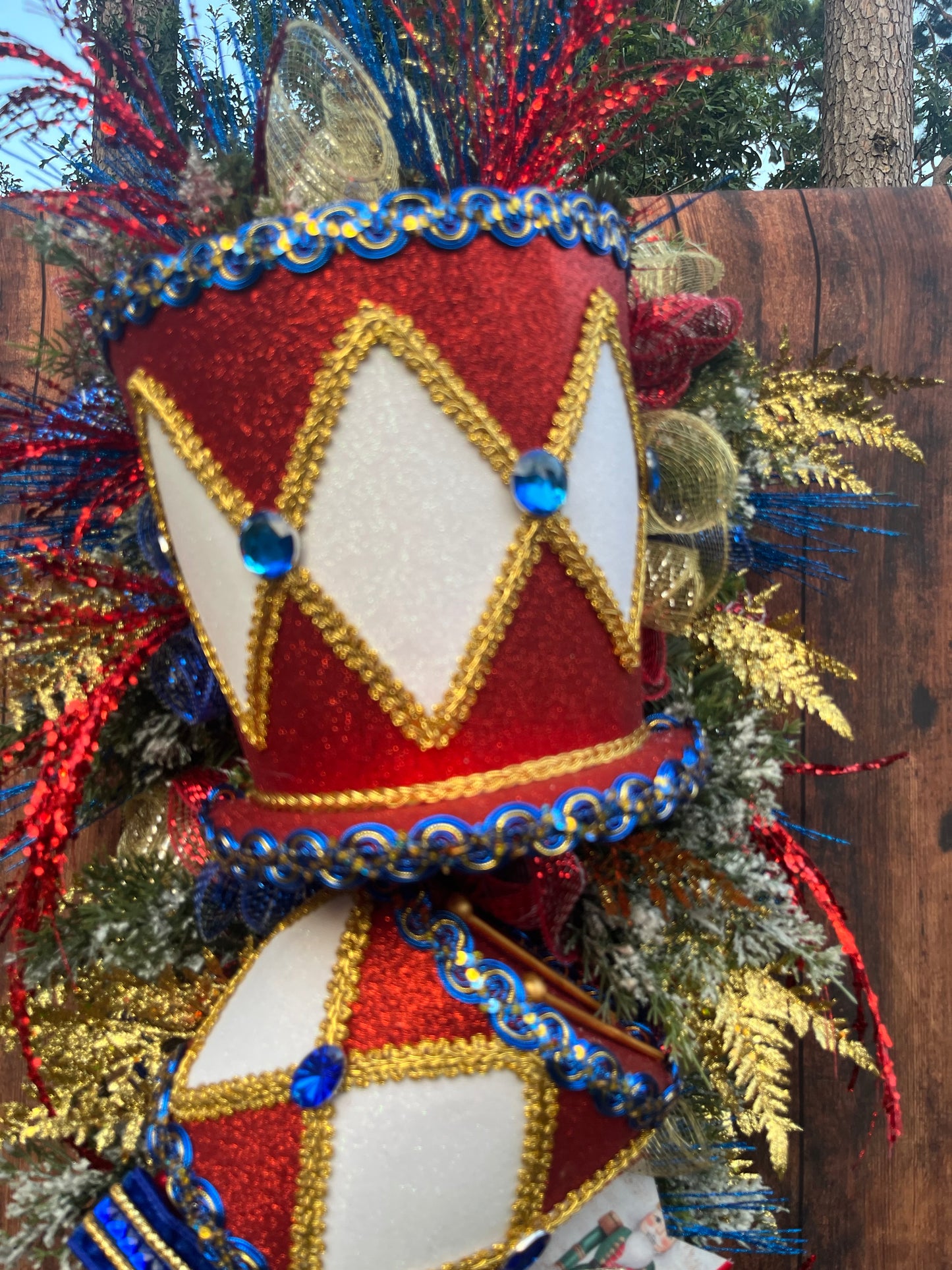Nutcracker Drum Christmas Swag – Red, Blue & Gold Holiday Door Decor with Glitter Picks & Nutcracker Ribbon