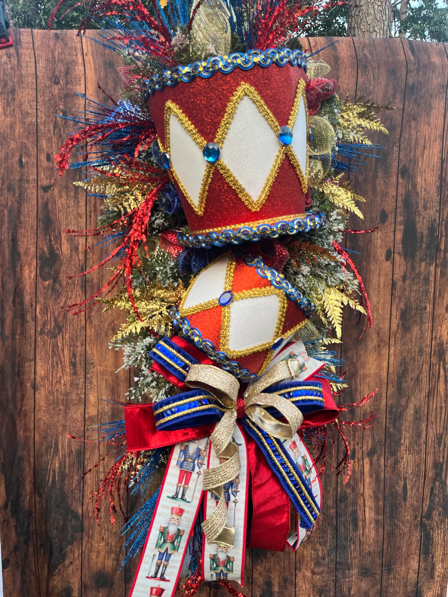 Nutcracker Drum Christmas Swag – Red, Blue & Gold Holiday Door Decor with Glitter Picks & Nutcracker Ribbon