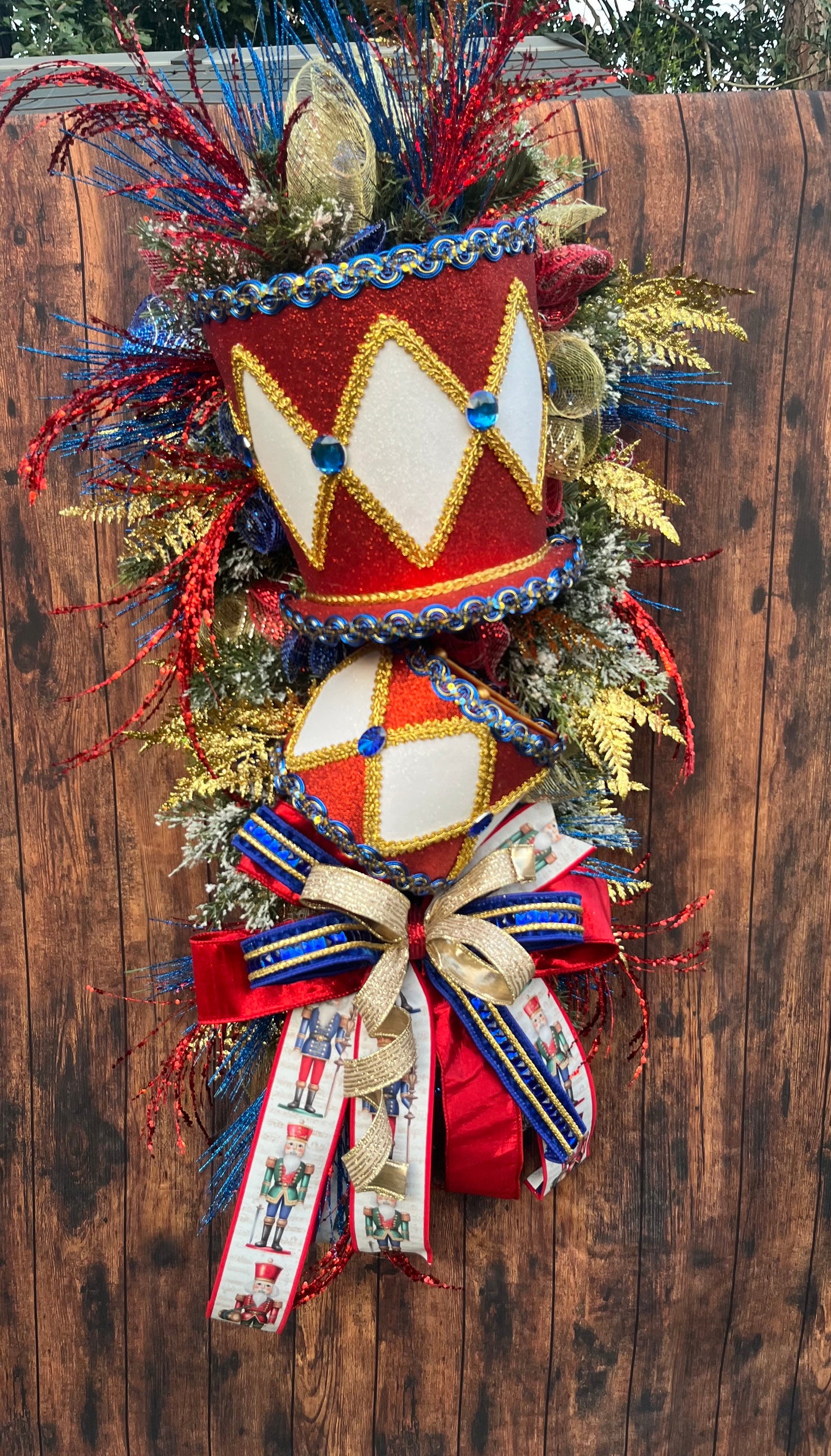 Nutcracker Drum Christmas Swag – Red, Blue & Gold Holiday Door Decor with Glitter Picks & Nutcracker Ribbon